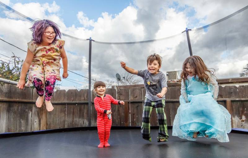 Ayla, 9, Alorra, 3, Aden, 6, Alilith, 5, enjoy the trampoline their mother, Bobbie Allison, recently bought and assembled for them. Allison said she had to leave Merced to find a landlord willing to accept her Section 8 housing voucher. It's far from child care and work in Merced, but in Atwater her children have a backyard where the trampoline and several rescued factory chickens provide the main entertainment.