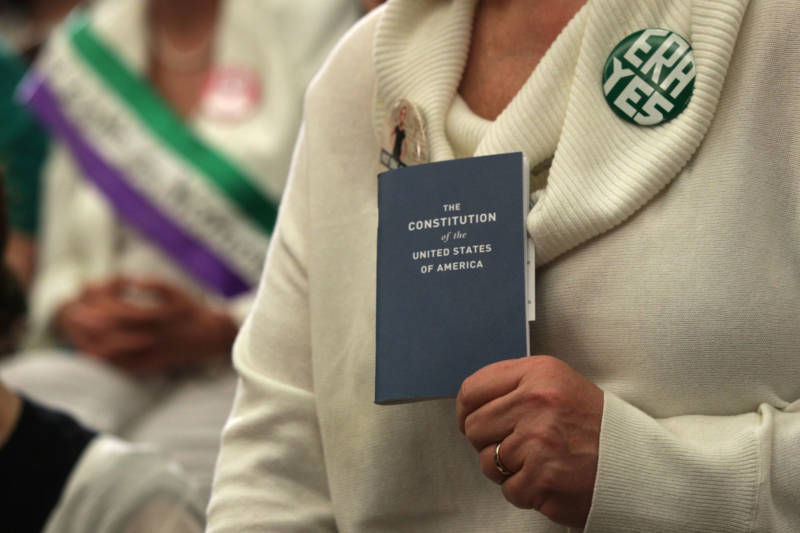 An activist holds a copy of the U.S. Constitution during a news conference on the Equal Rights Amendment on April 30, 2019, on Capitol Hill in Washington, D.C.