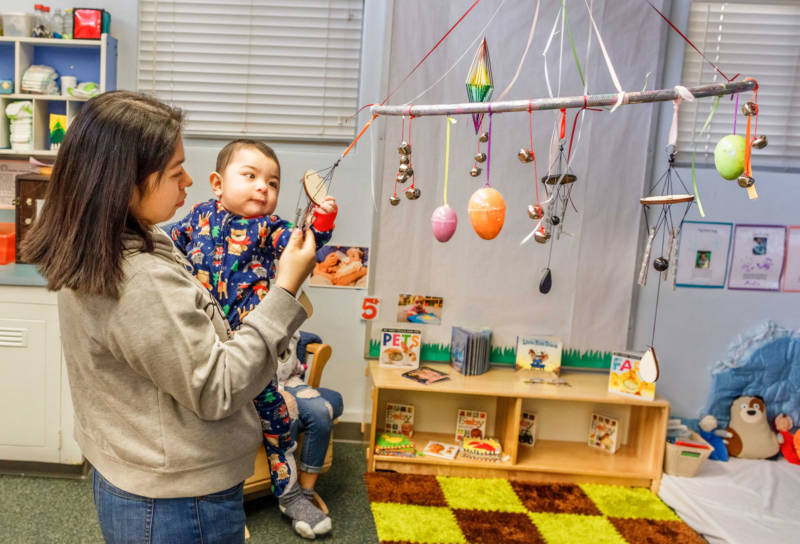 Alex Sandoval, age four months, begins his day at a child care center with his mom, Norma, playing with one of his favorite toys. Norma attends Yosemite High School while Alex attends the child care center attached to the school.