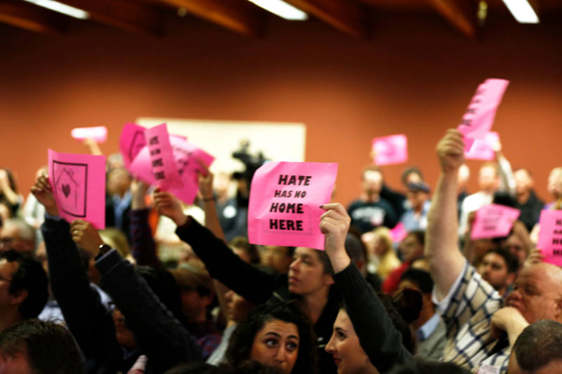 Attendees in support of the homeless navigation center hold 'Hate Has No Home Here' signs and cheer for San Francisco Mayor London Breed at a community meeting on April 3, 2019.