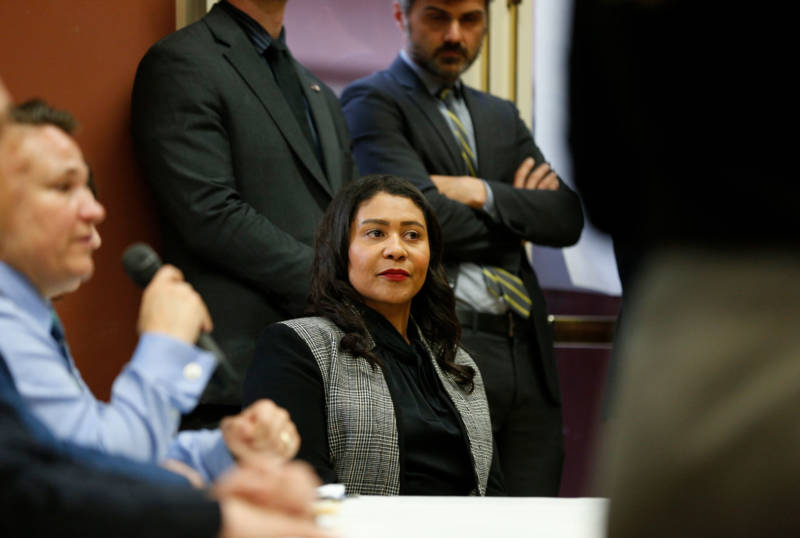 Mayor London Breed listens to comments after being shouted down at a community meeting on a proposed homeless navigation center in San Francisco.