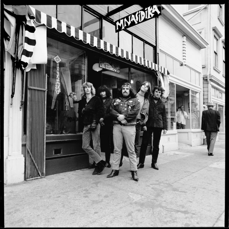 Members of the Grateful Dead stand outside Mnasidika in the Haight-Ashbury neighborhood. Mnasidika was an influential hippie boutique and meeting place in the 1960s.