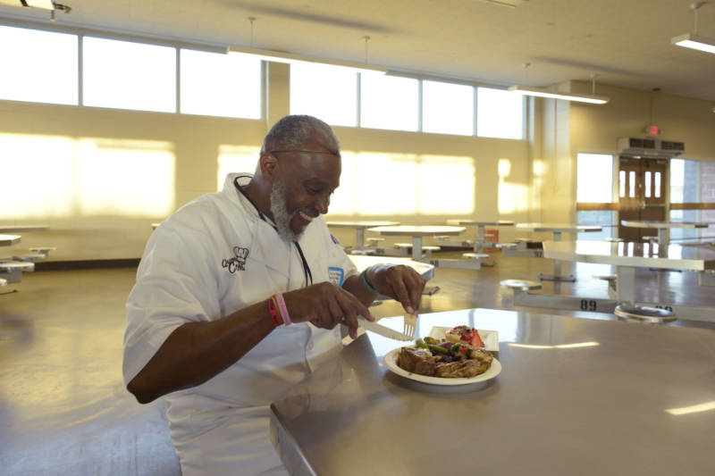 Alvis Taylor finally gets to enjoy his dinner after preparing food for 50 people at the fifth graduation of Quentin Cooks at San Quentin State Prison on May 22, 2019.