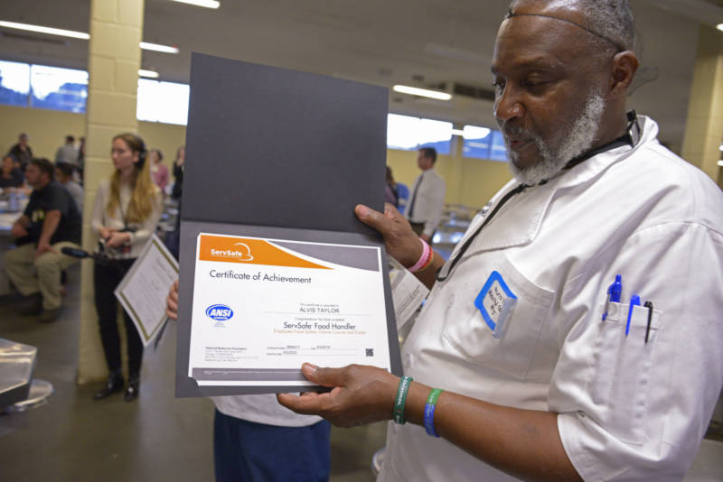Alvis Taylor shows off his ServSafe Food Handler's Certificate which comes in his diploma for graduation from the Quentin Cooks culinary program at San Quentin State Prison on May 22, 2019.