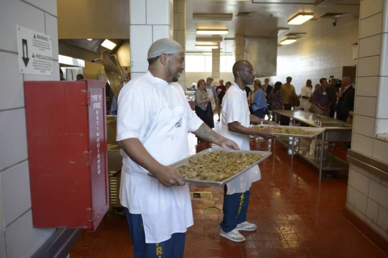 Inmates at San Quentin State Prison prepare shrimp for the fifth Quentin Cooks graduation dinner at San Quentin State Prison on May 22, 2019.