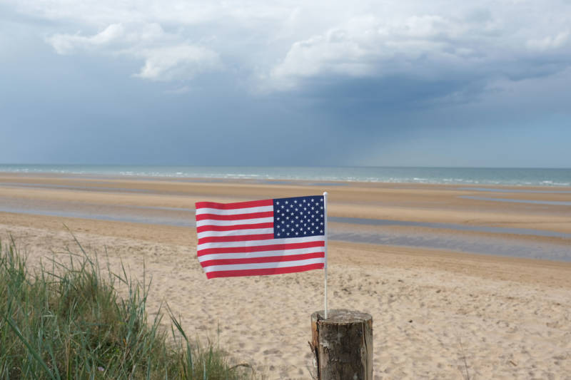 An American flag, likely left by a visitor, flies on Omaha Beach in Normandy on the 75th anniversary of the World War II Allied D-Day invasion on June 06, 2019 near Colleville-Sur-Mer, France.