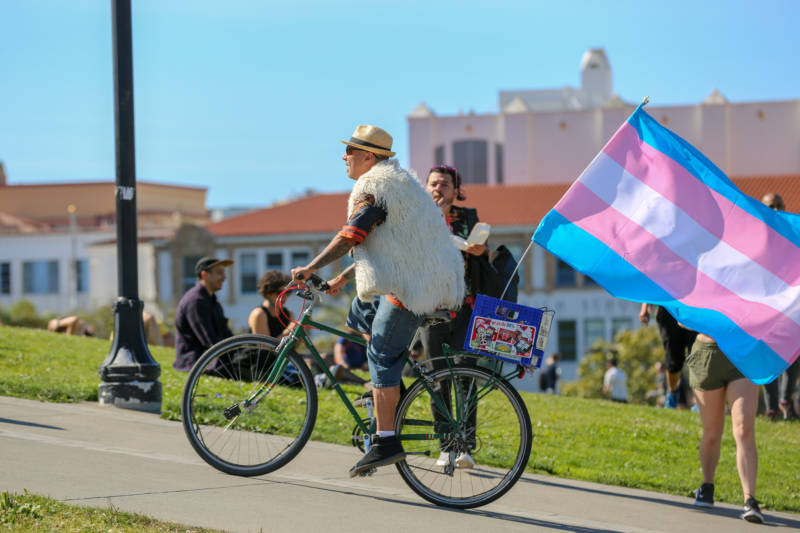 Enrique Cancél bikes through the Trans March crowd at Dolores Park. Cancél has lived in San Francisco for 25 years and attended every Pride celebration. 'This is a gathering of the tribes. This is when we come out in celebration and try to be as inclusive as we can be. It’s wonderful.'