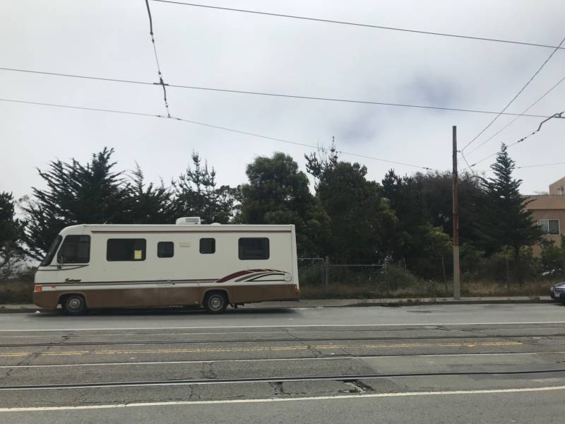 An RV is parked in Balboa Park up the street from San Francisco's first proposed safe parking lot where people living in their vehicles will be able to park legally and access services. A sign on the RV warns its occupant that they need to move the vehicle. July 16, 2019.
