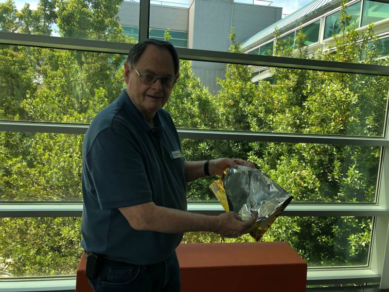 Chabot Space and Science Center astronomer Gerald McKeegan shows off some of the Apollo 11 spacesuit's 21 inner layers.