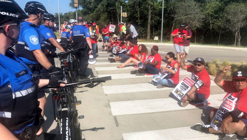 Airline catering workers represented by the Unite Here union block an entrance to American Airlines' corporate headquarters in Fort Worth, Texas on Tuesday.