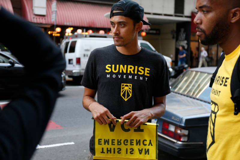 Steven Marquardt, of the youth-led Sunrise Movement, helps lead a protest at the Hilton in San Francisco on Aug. 23, 2019 where they are asking the DNC to host a climate debate.