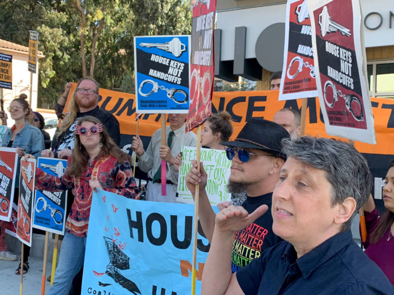 Sara Shortt with the San Francisco Coalition on Homelessness (right) leads protesters in chants including "housing not handcuffs" during a visit by HUD Secretary Ben Carson on Tuesday.