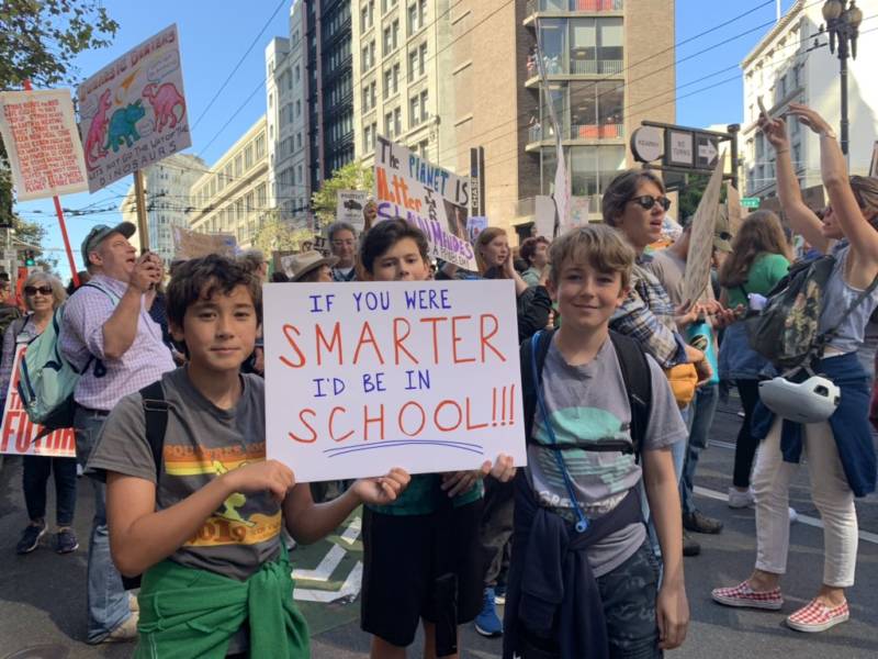 Students hold a sign reading, "If you were smarter, I'd be in school" during a climate march on Sept. 20, 2019.