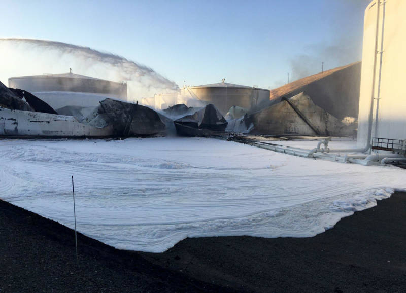 Crews covered remaining flammable material with foam at NuStar Energy's storage facility on Tuesday in an attempt to prevent additional flare ups.