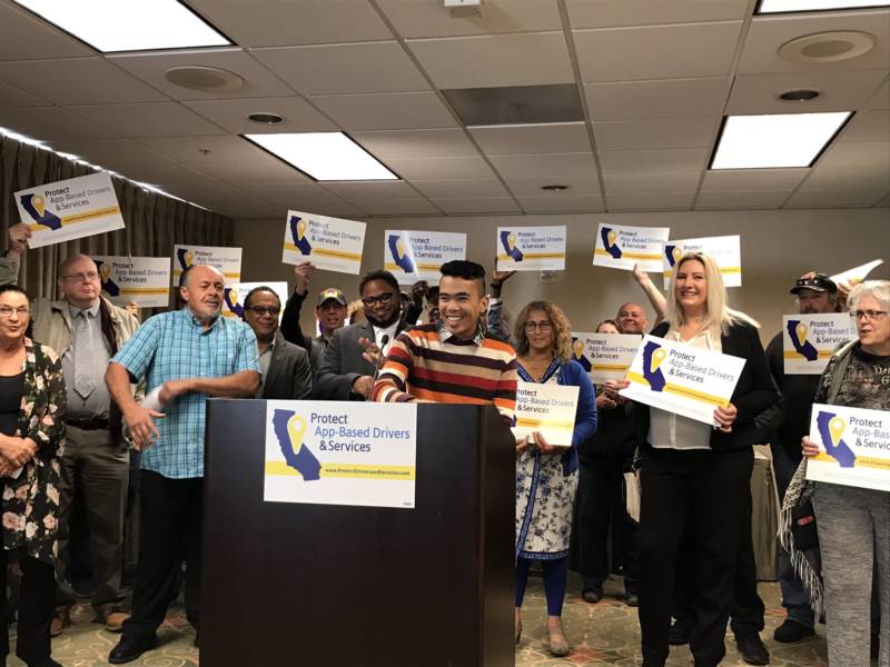 Akamine Kiarie, who drives for Lyft in the Sacramento region while attending college, speaks in favor of a potential November 2020 California ballot measure backed by gig companies at a news conference on Oct. 29, 2019.