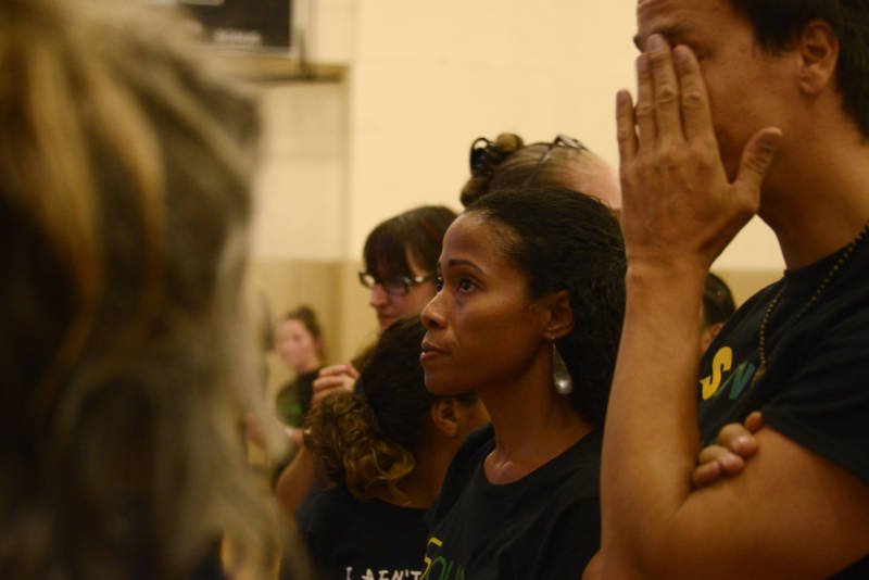 Stracey Gordon, parent of a Kaiser Elementary student, watches other parents, teachers and community members speak at an Oct. 23, 2019 Oakland Unified School district board meeting where police arrested and injured protesters.