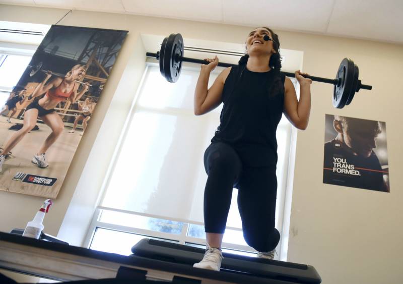 Photo of Ruby Sultan lifting weights. 
