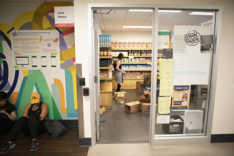 Photo of students sitting outside the food pantry room at UC Berkeley.