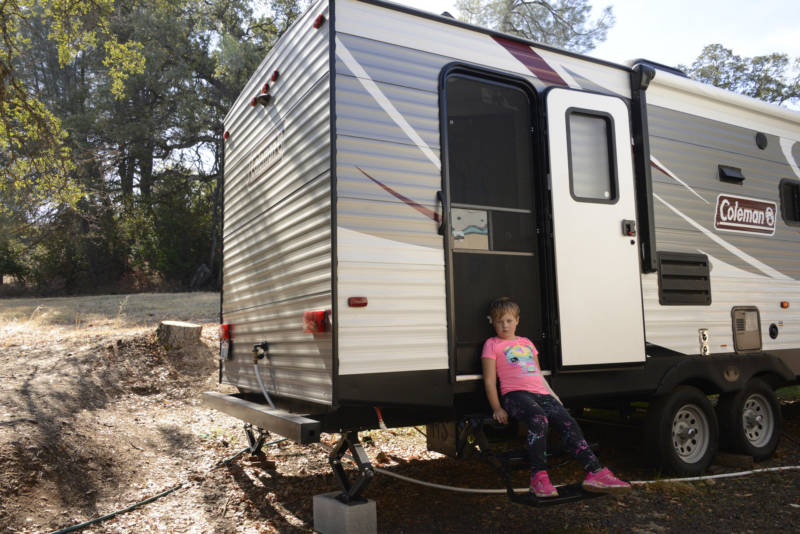 Aroara sits outside the trailer where she lives with her mother in Butte County.
