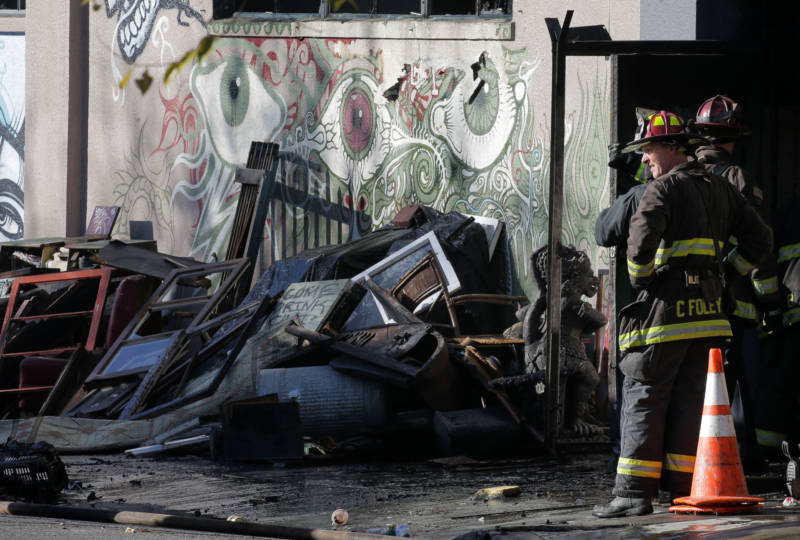 Firefighters work outside the Ghost Ship warehouse on the morning of Dec. 3, 2016 in Oakland, the day after a fire there claimed the lives of 36 people.