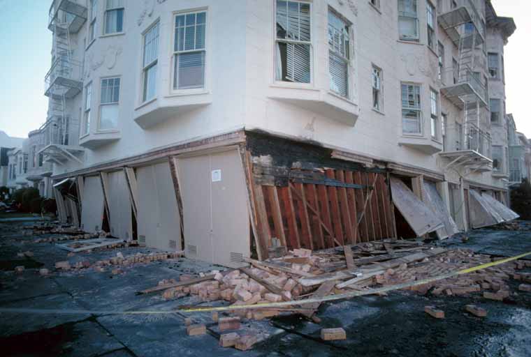 Absence of adequate shear walls on the garage level exacerbated damage to this structure at the corner of Beach and Divisadero Streets, Marina District. [J.K. Nakata, U.S. Geological Survey]