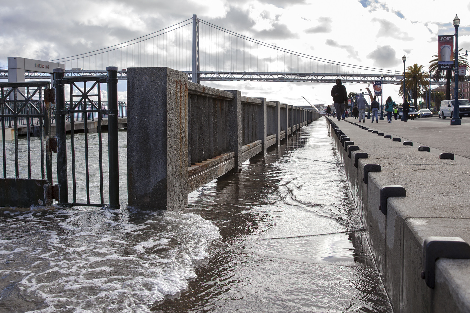 Walkways along Pier 14 at the San Francisco Embarcadero begin to flood during the high point of a king tide on January 11, 2017.