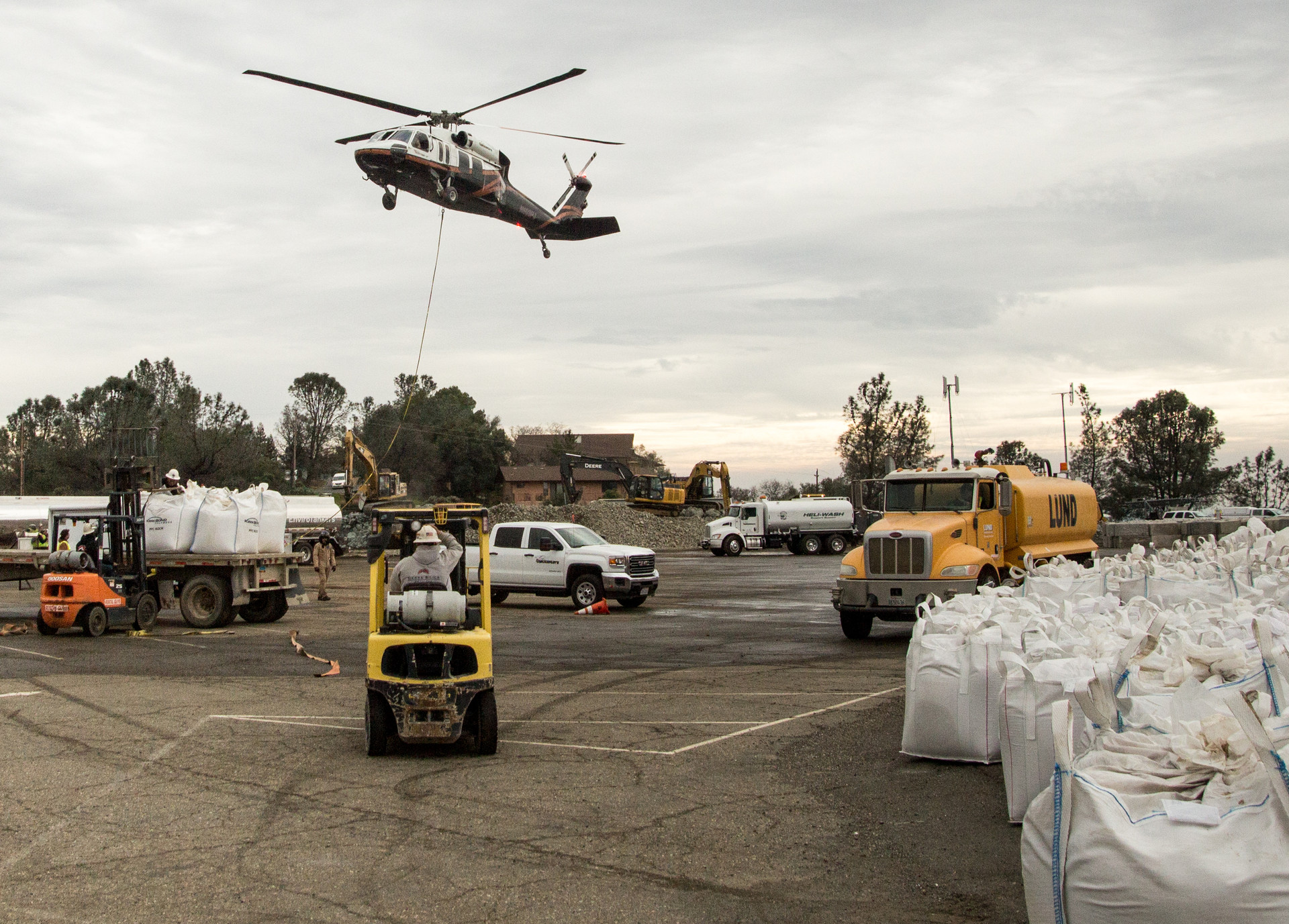 Blackhawk helicopters buzzed back and forth across the dam, carrying 4,000-pound sacks of rock and gravel.