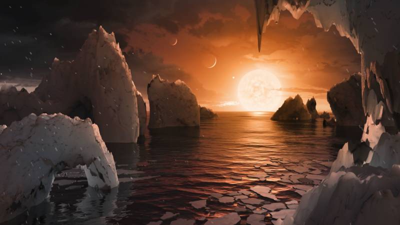 Artist concept of an exoplanet with possible surface water in the TRAPPIST-1 system, 40 light years from our solar system.