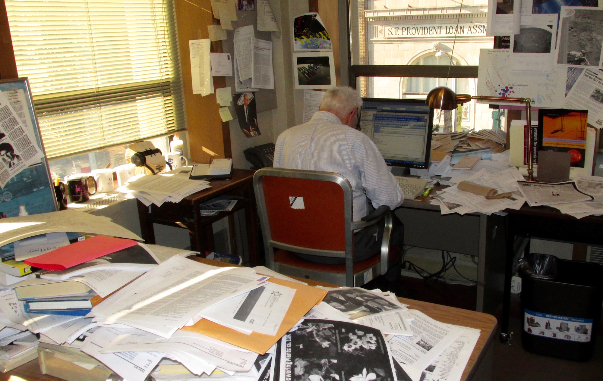There was no mistaking Perlman's work space, piled high with research.