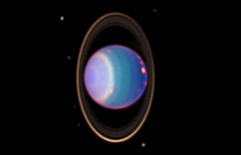 An infrared image of the ice giant Uranus and its thin rings, captured by the Hubble Space Telescope. 