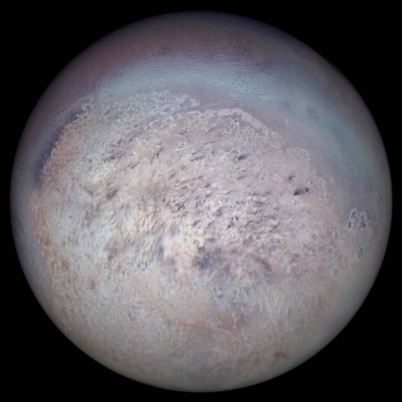 The largest moon of either ice giant planet, Triton, imaged by Voyager 2 in 1989. Triton may be one of the coldest spots in the solar system, though still shows signs of activity as it spews out plumes of nitrogen gas. 