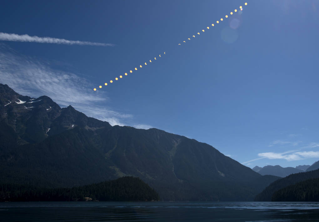 This composite image,  from NASA shows the progression of a partial solar eclipse over Ross Lake, in Northern Cascades National Park, Washington.