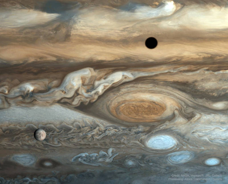 Image of Jupiter and its famous "Great Red Spot," with the moon Europa set in the foreground. The dark circle in the upper right is the shadow of the moon Io. 