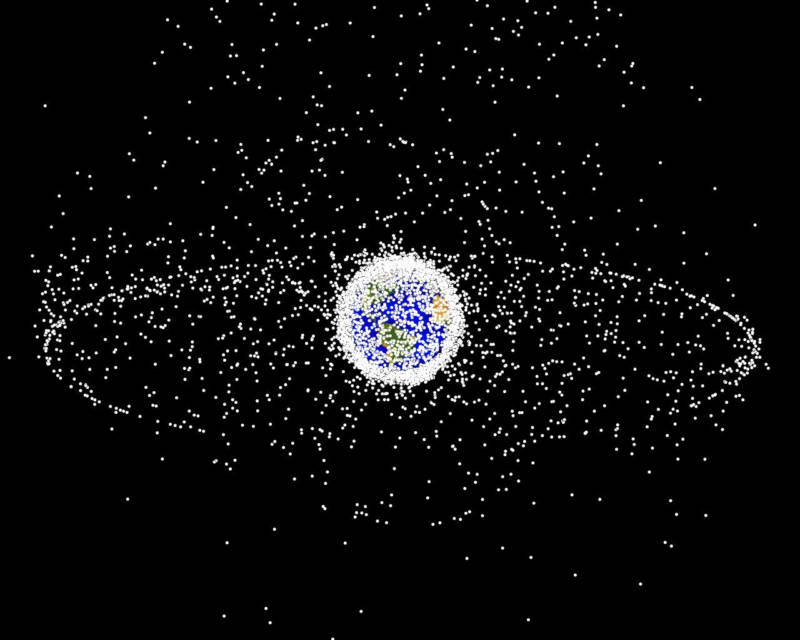 Map of artificial objects in orbit around Earth. The high-density sphere of objects in low-Earth orbit hugs the Earth, while the sparser population out toward the geosynchronous distance forms a ring. 
