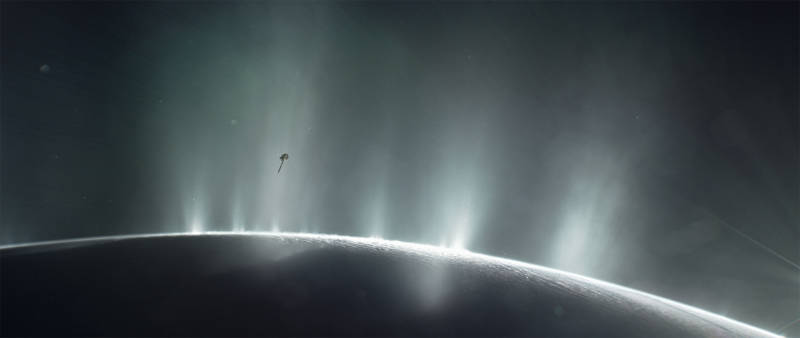 Water plumes erupting from enormous cracks in the crust of Saturn's moon Enceladus. An image of the Cassini spacecraft is superimposed to depict one of it's flights through the water plumes. 