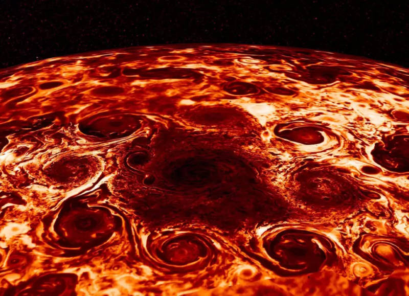 Infrared image of a central cyclone attended by eight smaller cyclones in Jupiter's north polar region. 