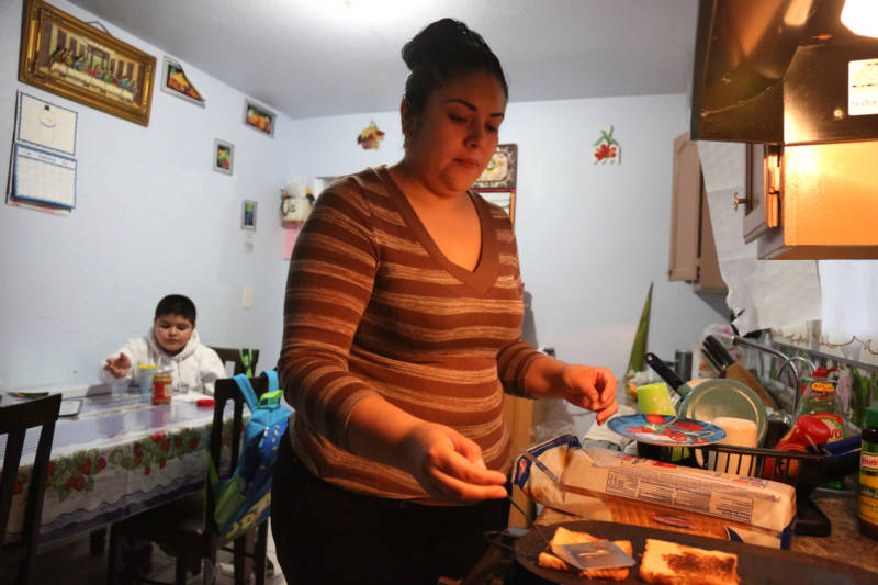 Maria Bernal, 30, cooks breakfast for her son Edwin Bernal, 9, before school at their home in Los Angeles. His mother fears that under the Trump administration the program will be in danger.