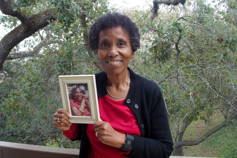 Andrea Gourdine holds a photo of her mother, Gladys Brown, who died in 2012 after being diagnosed with Alzheimer’s. Brown donated her brain to the University of California-Davis, for research.