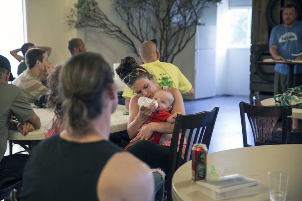 Heather Menzel feeds her daughter, Bella, during a Christian-based drug recovery meeting in Wofford Heights, Calif., in June 2016. Menzel is taking a maintenance dose of methadone to treat her heroin addiction.